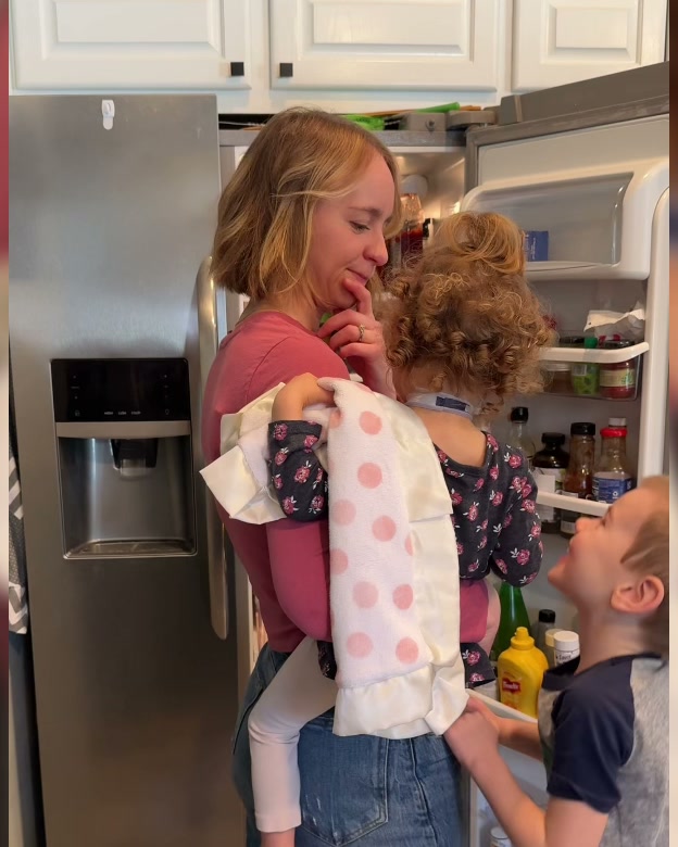 A mom at the fridge with her kids